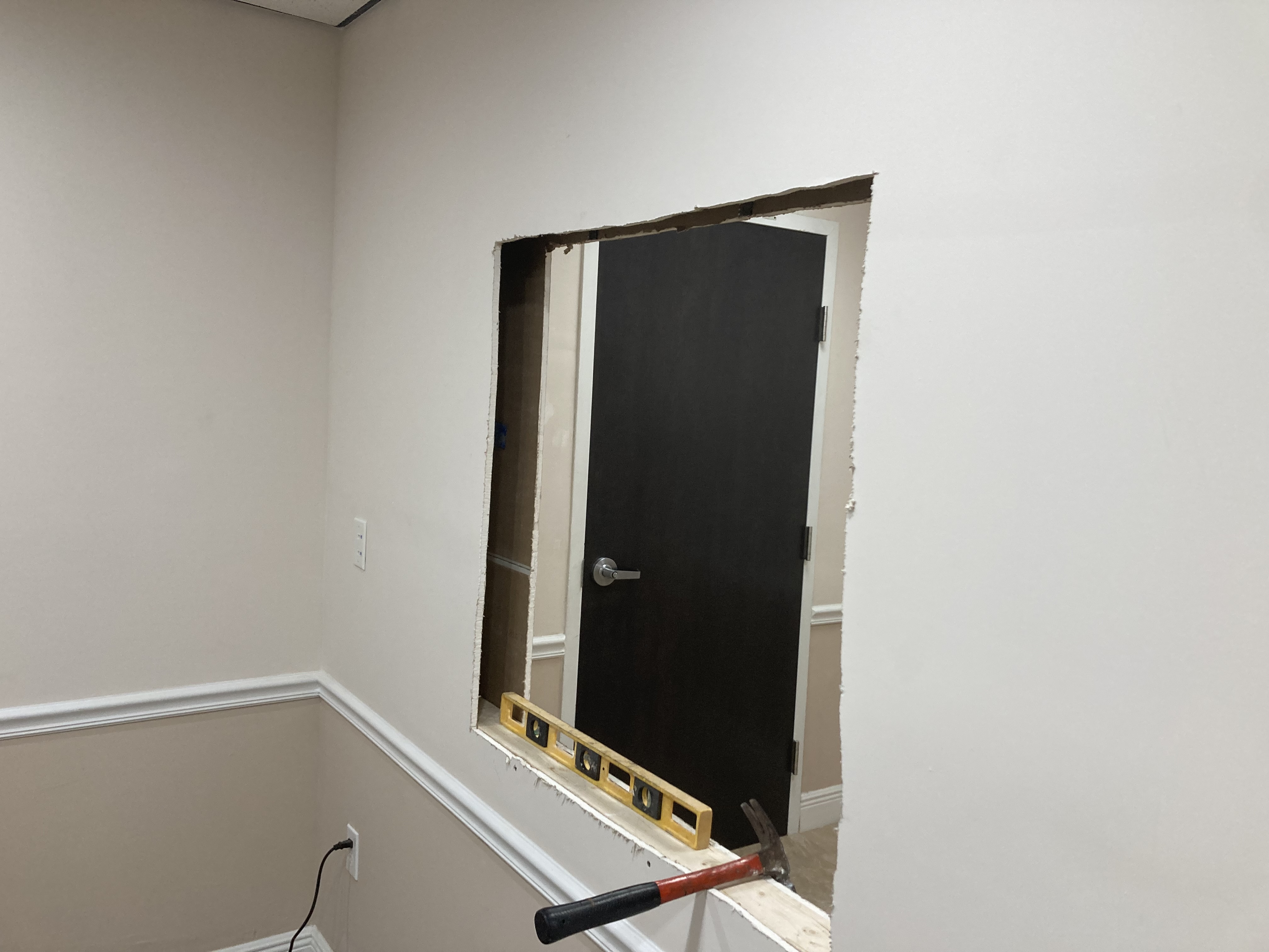 Office wall opening and framing in progress